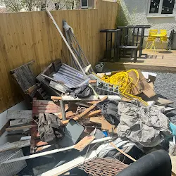 Garage before clearance in Bristol, filled with timber, rubble and broken furniture